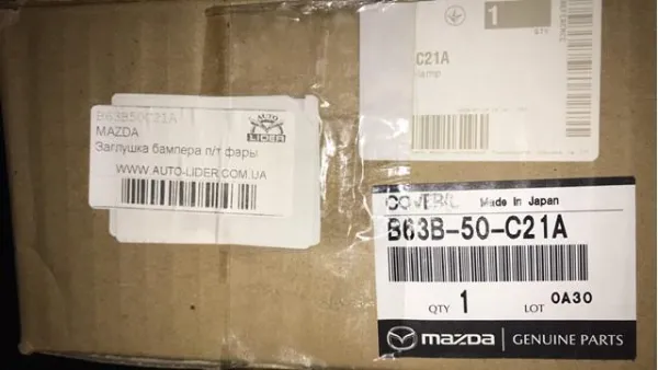 Заглушка/ решітка протитуманних фар бампера переднього, ліва B63B50C21A Mazda